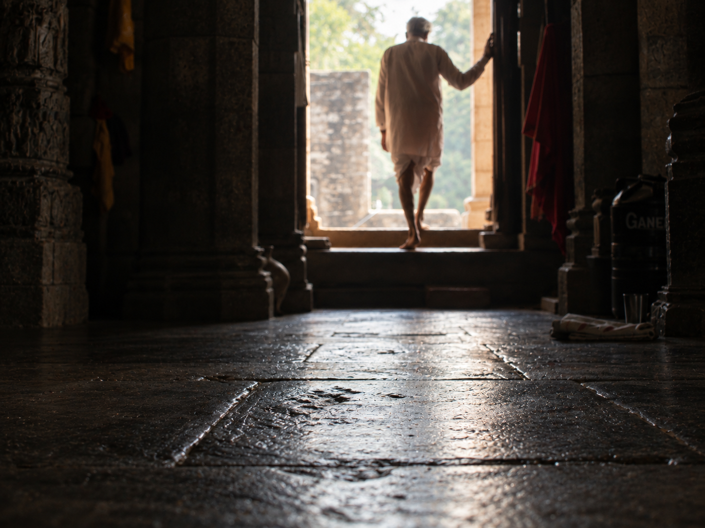 Bare feet on the stone floor of a temple interior